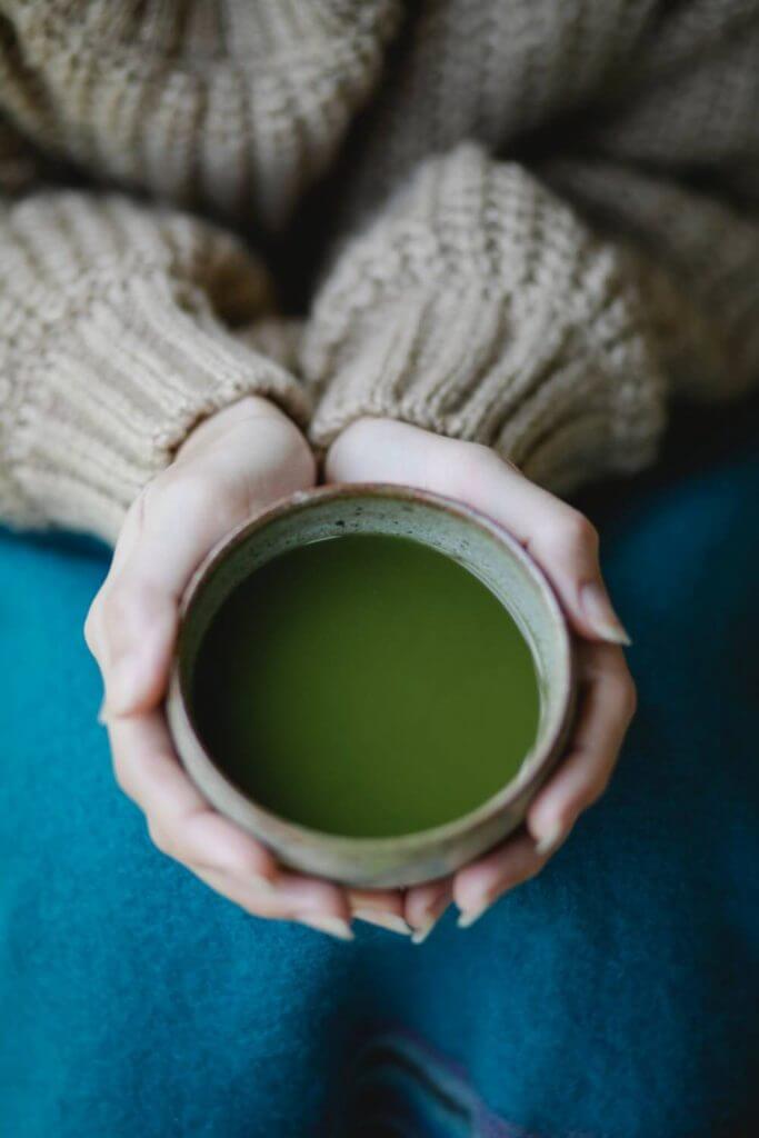 Two hands wrapped around a mug